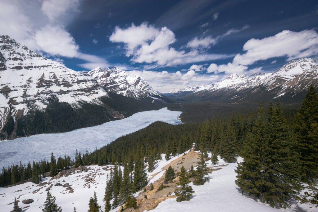 a snow covered mountain with a lake in the middle